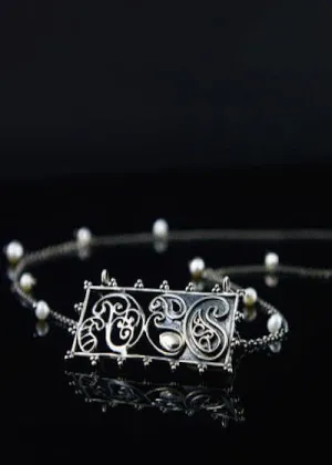 Artistic, rectangular paisley pendant on pearls interspersed chain