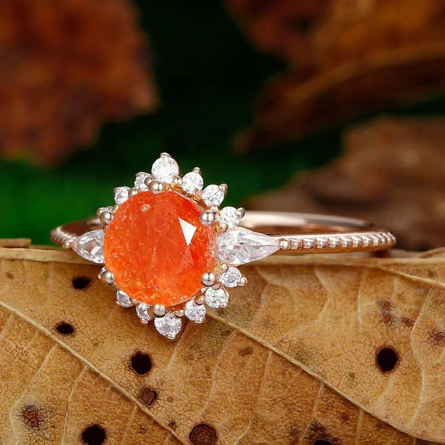 dainty 1.25ct round cut orange sunstone  nature inspired sunstone rose gold sunburst halo  Ring