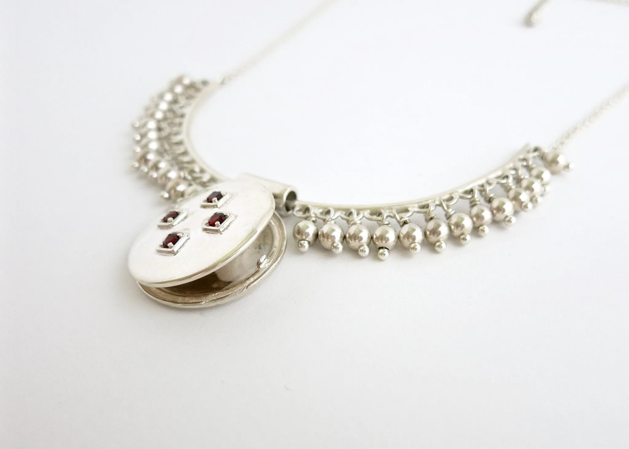 Vintage inspired, unique locket necklace in sterling silver and garnet